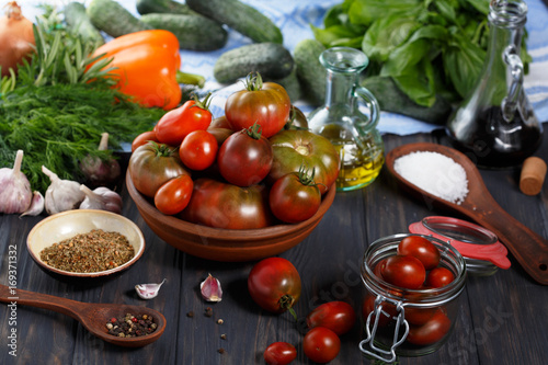 Tomatoes and seasoning on the table. Late summer.