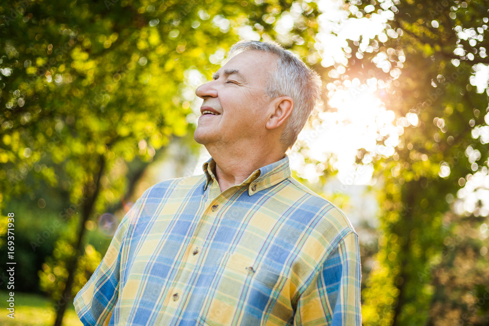 Happy senior man is enjoying fresh air in nature. Happy senior man is enjoying fresh air in nature.