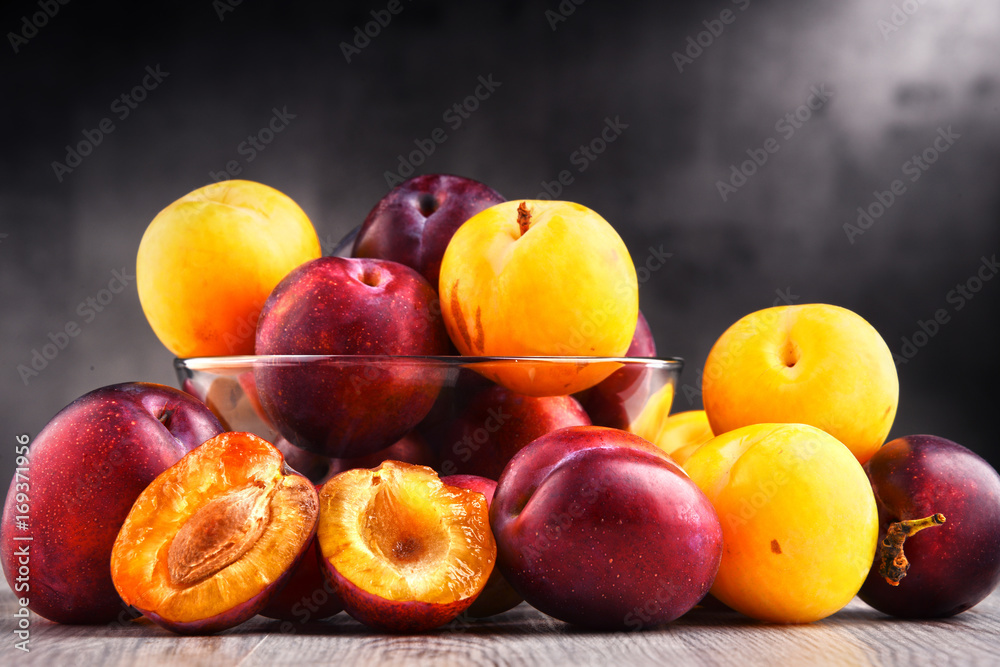 Composition with bowl of sweet ripe plums