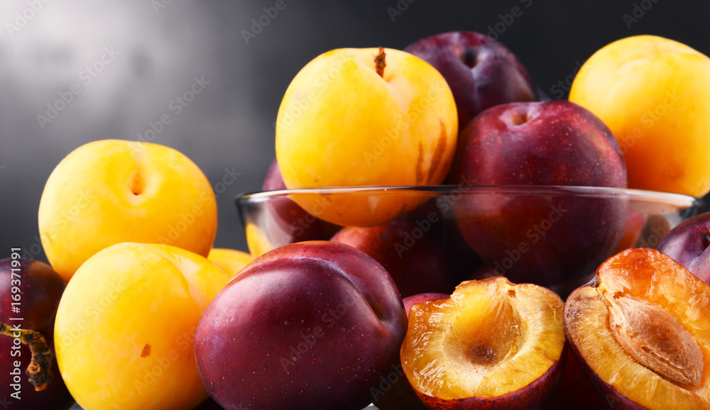 Composition with bowl of sweet ripe plums