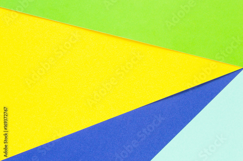 Colored papers geometry flat composition background with yellow, green and blue tones