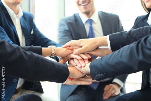 Group of businessman team touching hands together. Selective focus.