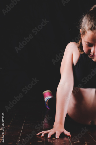 Young fitness girl on black background. Sport or  healthy lifestyle concept