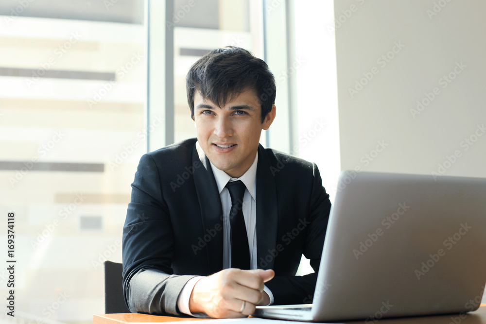 Young businessman working in the office with laptop. Young businessman working in the office with laptop.