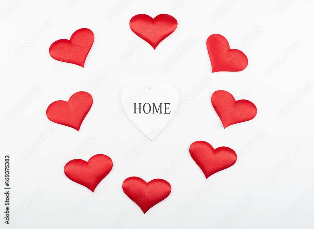 Top view of a white heart next to red hearts on white background. Isolated.