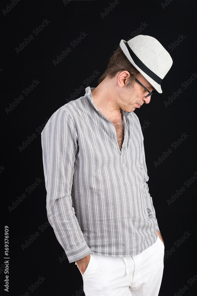 attractive candid european middle-aged male with head and striped shirt in thoughtful pose - studio shot on black background attractive candid european middle-aged male with head and striped shirt in thoughtful pose - studio shot on black background