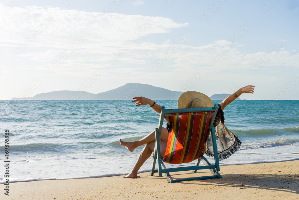woman relaxing on sun bed sofa lounge chair on holidays woman relaxing on sun bed sofa lounge chair on holidays