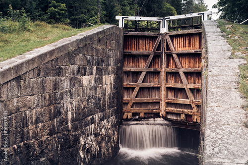 Old flood gate or sluice leaking water at the doors