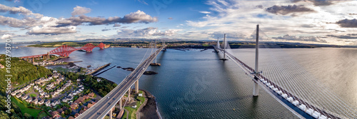 Quadro em tela The new Queensferry Crossing bridge (on the right) over the Firth of Forth with the older Forth Road bridge (on the left) and with the iconic Forth Rail Bridge in the far left
