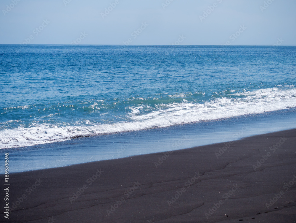 Black volcanic beach in eastern Bali Indonesia
