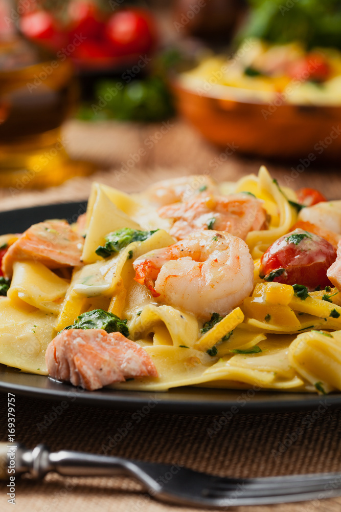 Traditional Italian fettuccini with salmon, shrimp and spinach. Traditional Italian fettuccini with salmon, shrimp and spinach.