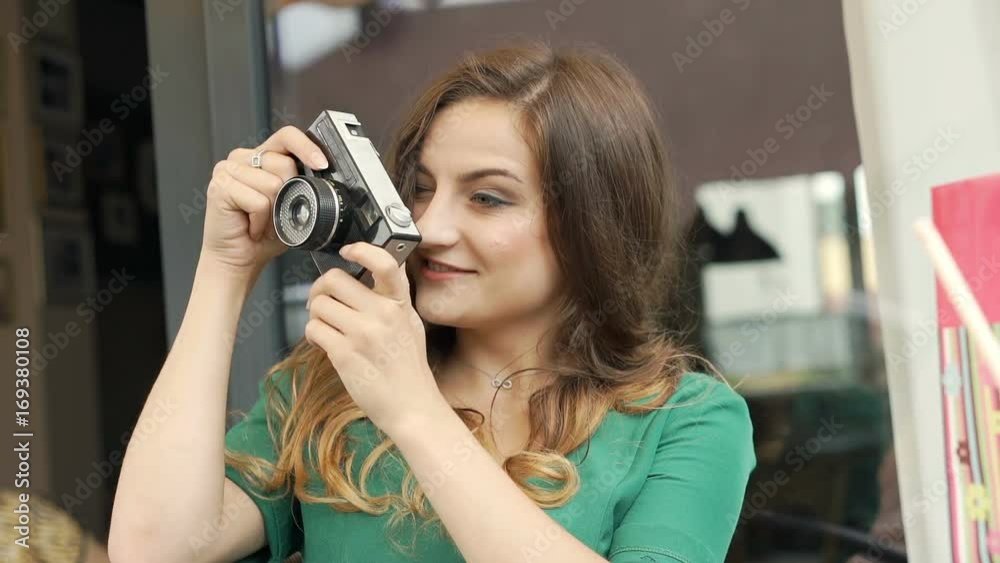 Stylish brunette sitting in the outdoor cafe and doing photos on old camera, steadycam shot
Stylish brunette sitting in the outdoor cafe and doing photos on old camera, steadycam shot