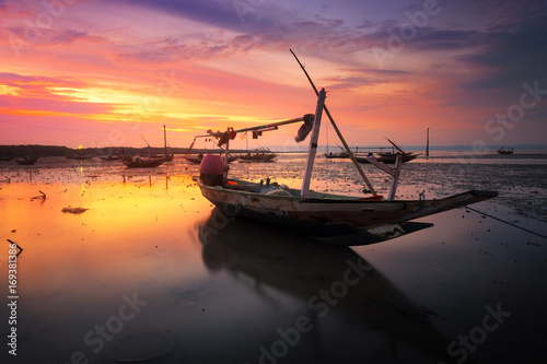 Fotografie Fishing boat at beach closed to Suramadu bridge in Surabaya, Indonesia