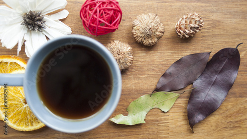 Coffee, fruit and flowers on a wooden table. The concept of the autumn morning.