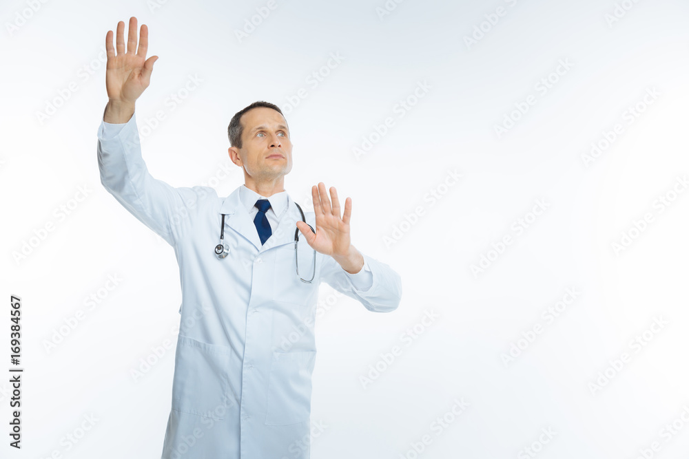 Serious medical professional touching invisible wall Serious medical professional touching invisible wall