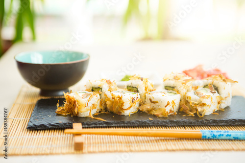 Sushi rolls on black slate surface. Japanese food. Hot fried Sushi Roll photo