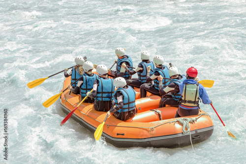 Group of people rafting on white water, active vacations, team concept
