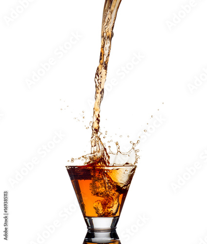 Whiskey splash out of glass isolated on white background