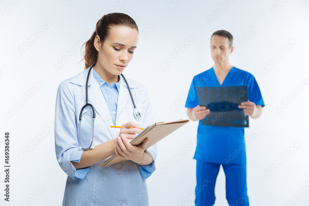 Female medical professional making diagnosis Female medical professional making diagnosis