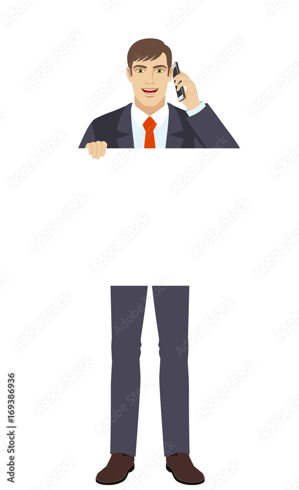 Businessman holding white blank poster and talking on the mobile phone Businessman holding white blank poster and talking on the mobile phone