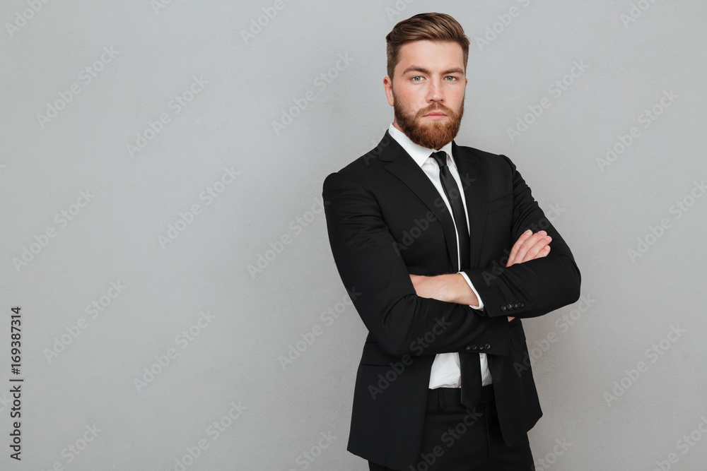 Confident young businessman in suit standing with arms folded Stock ...