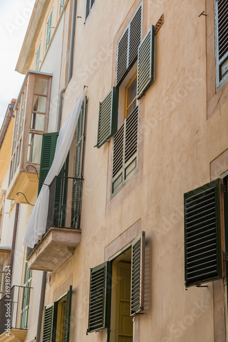 Green Shutters on Old Plaster Apartment