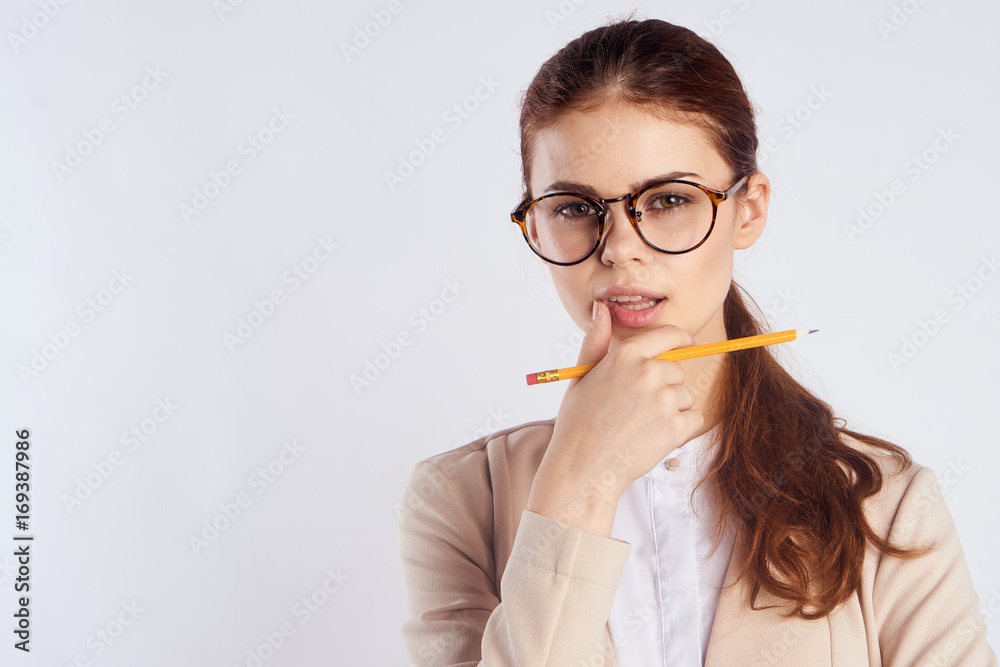 Beautiful woman with glasses holds a pencil, portrait, blank space for copy Beautiful woman with glasses holds a pencil, portrait, blank space for copy
