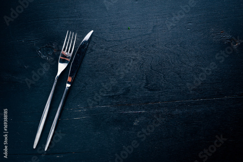Cutlery. On a wooden background. Top view. Free space for text.