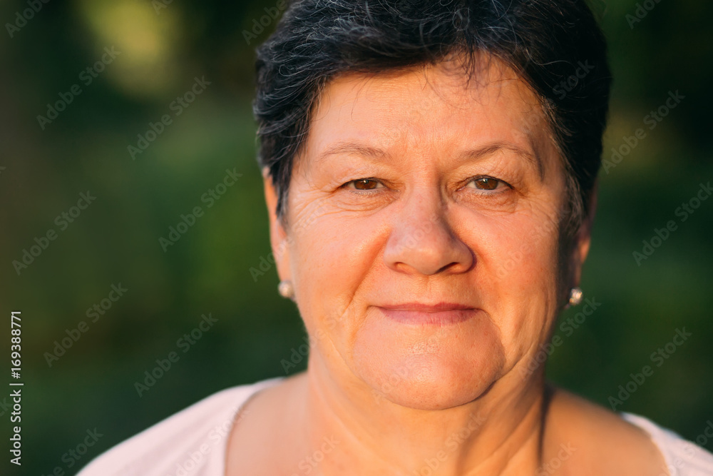 Closeup portrait of old kind woman full of happiness looking at Closeup portrait of old kind woman full of happiness looking at