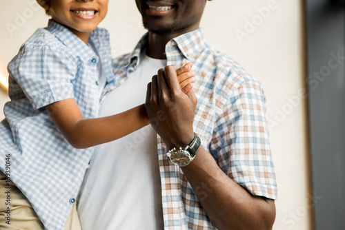 african american father carrying son