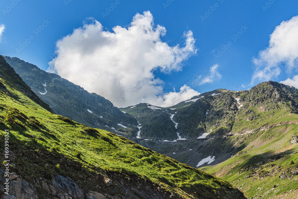 Mountain landscape of the high rocky Fagaras mountains with famous Transfagarasan road in Carpathians, Romania