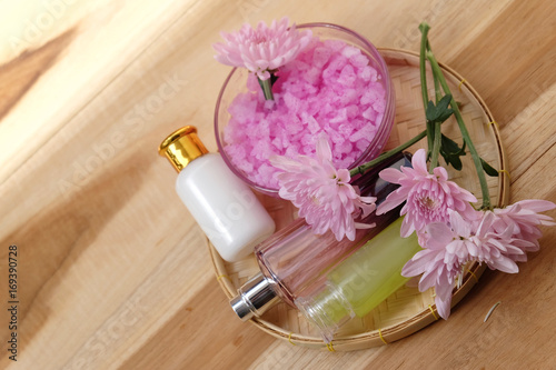 Skin cream  shampoo  salt spa and flower On a wooden background. Spa Concept.