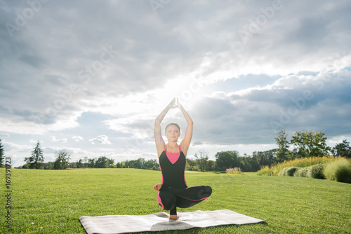 woman performing toestand yoga pose photo