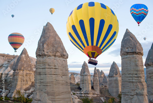 Hot air balloons over unique geological formations in Cappadocia, Turkey
