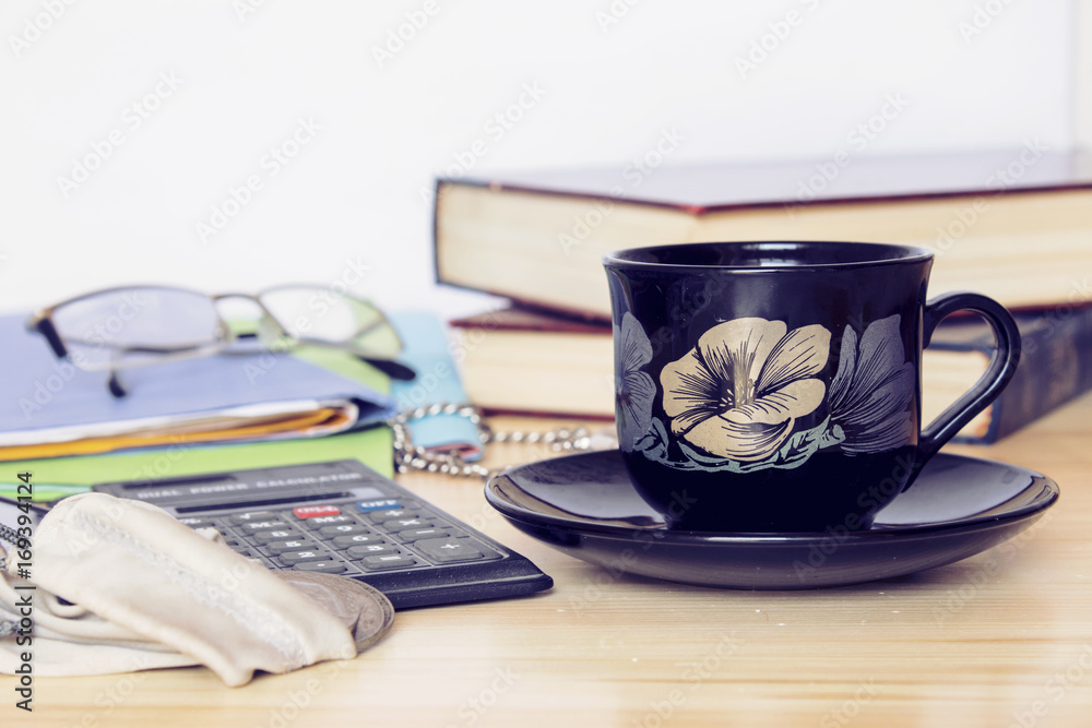 place of work pocket watch books coffee on wood table