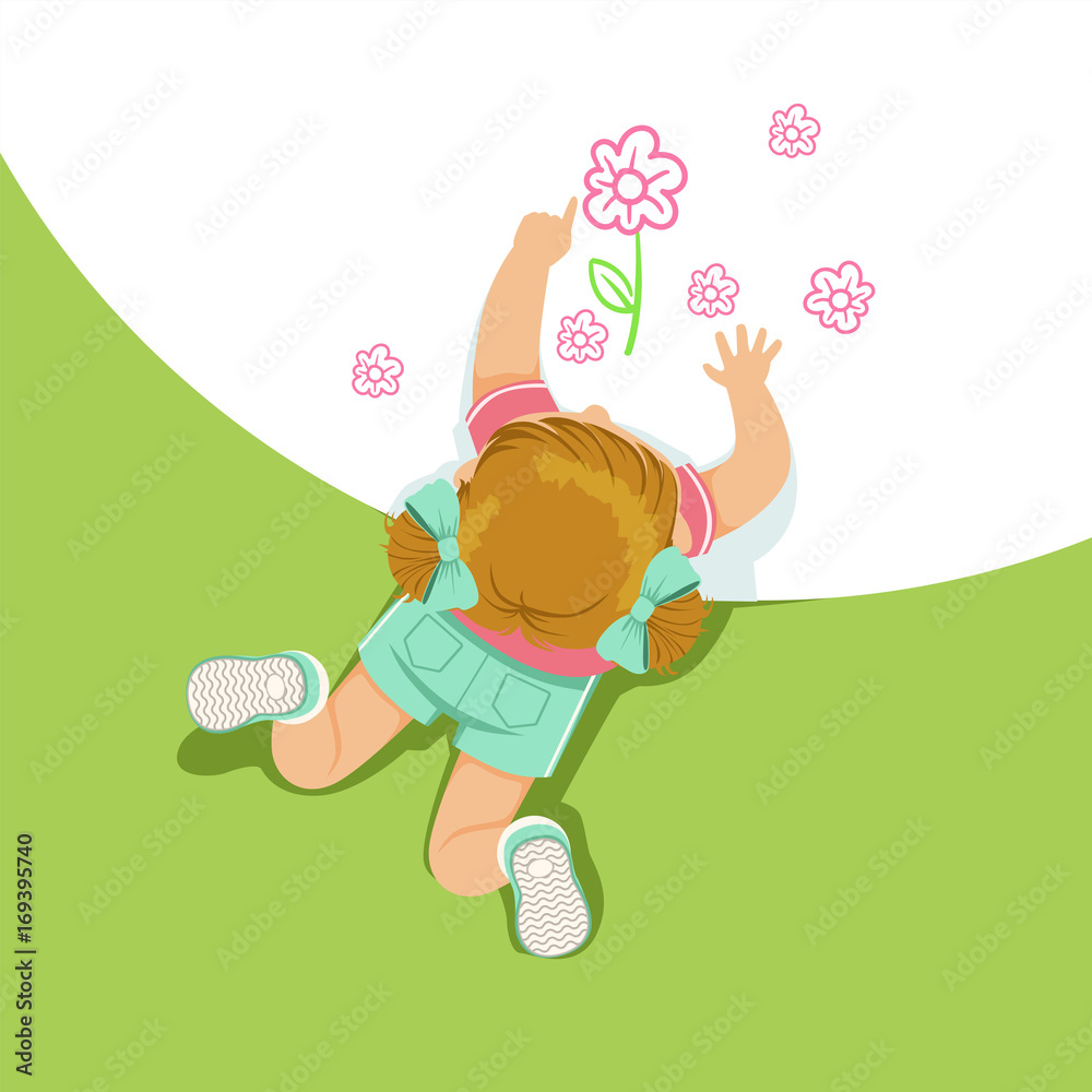 Little girl lying on her stomach and painting flowers with her hands