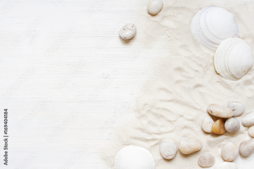 White wooden background with sand, pebble and shells