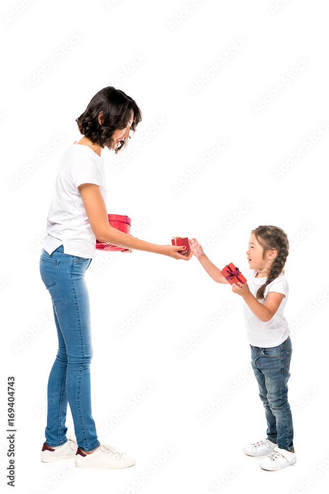attractive asian mother and adorable daughter with gift boxes, isolated on white attractive asian mother and adorable daughter with gift boxes, isolated on white
