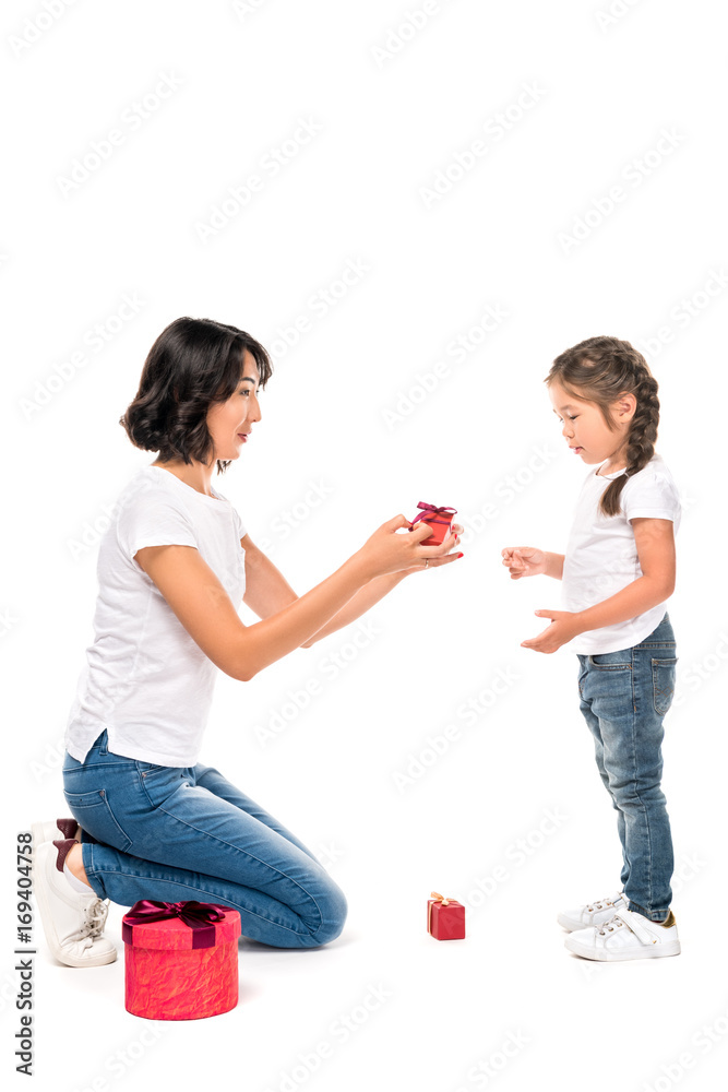 happy asian mother and daughter with gift boxes, isolated on white happy asian mother and daughter with gift boxes, isolated on white