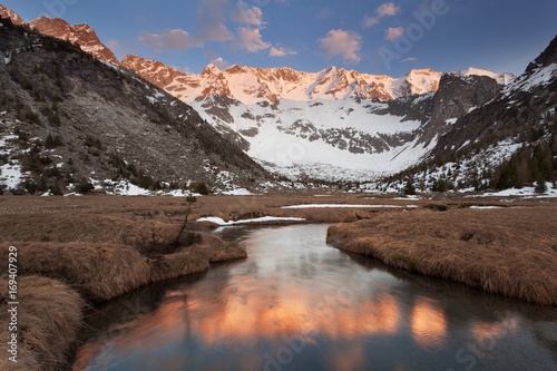 Aviolo lake, Vezza d'Oglio, Adamello natural park, Lombardy. The last lights illuminate the imposing chain of Baitone