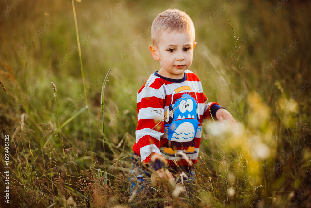 Little boy stands on green field Little boy stands on green field