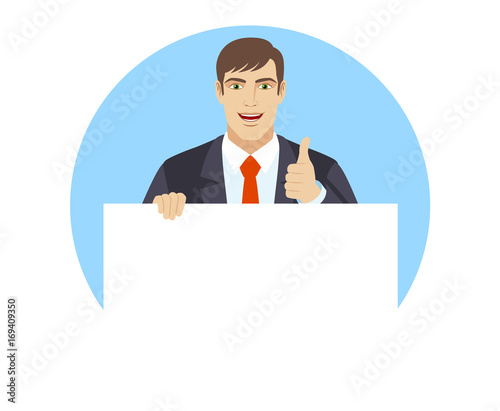 Businessman holding white blank poster and showing thumb up