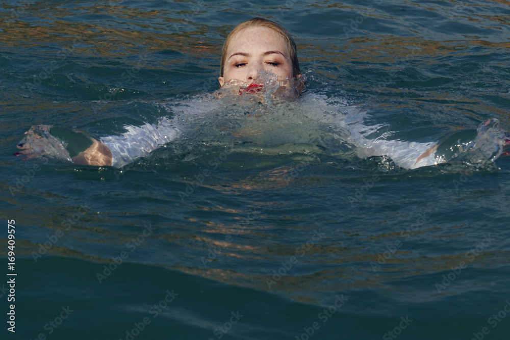 business woman sinking into the sea