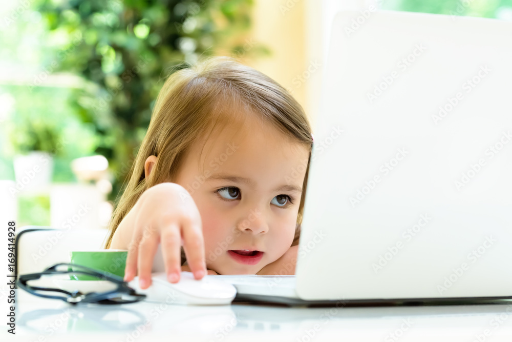 Little girl at her desk and computer at home Little girl at her desk and computer at home