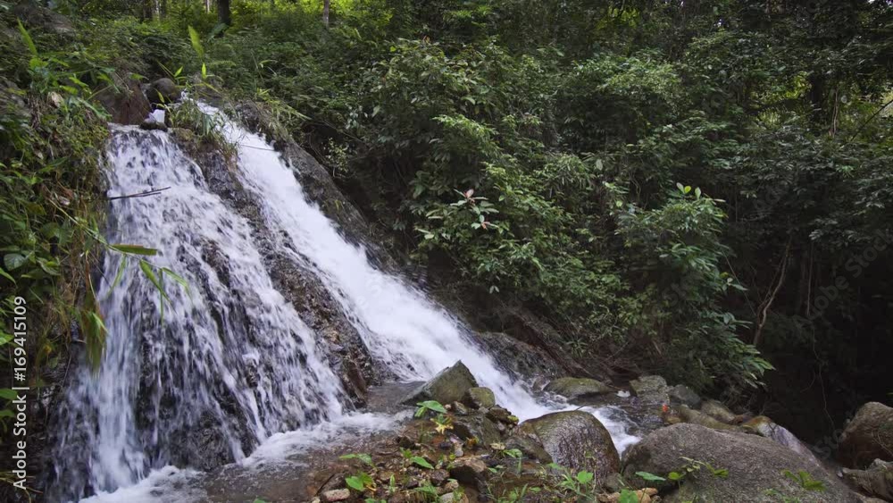 Small waterfall in tropical forest on Phuket island. Video 4k with sounds
