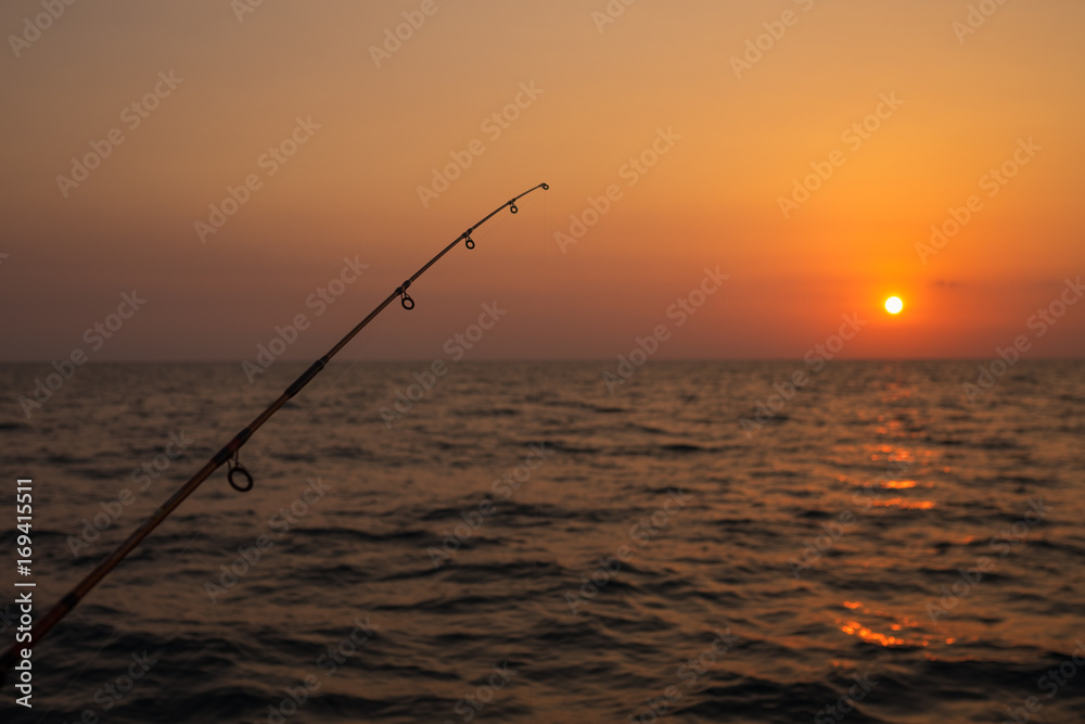 Fishing rod on the background of beautiful sunset Stock Photo | Adobe Stock