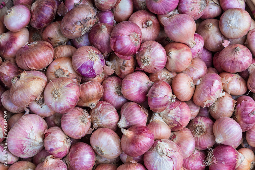 Red onions in plenty on display at local farmer's market. Big Red Onions Background Red onions in plenty on display at local farmer's market. Big Red Onions Background
