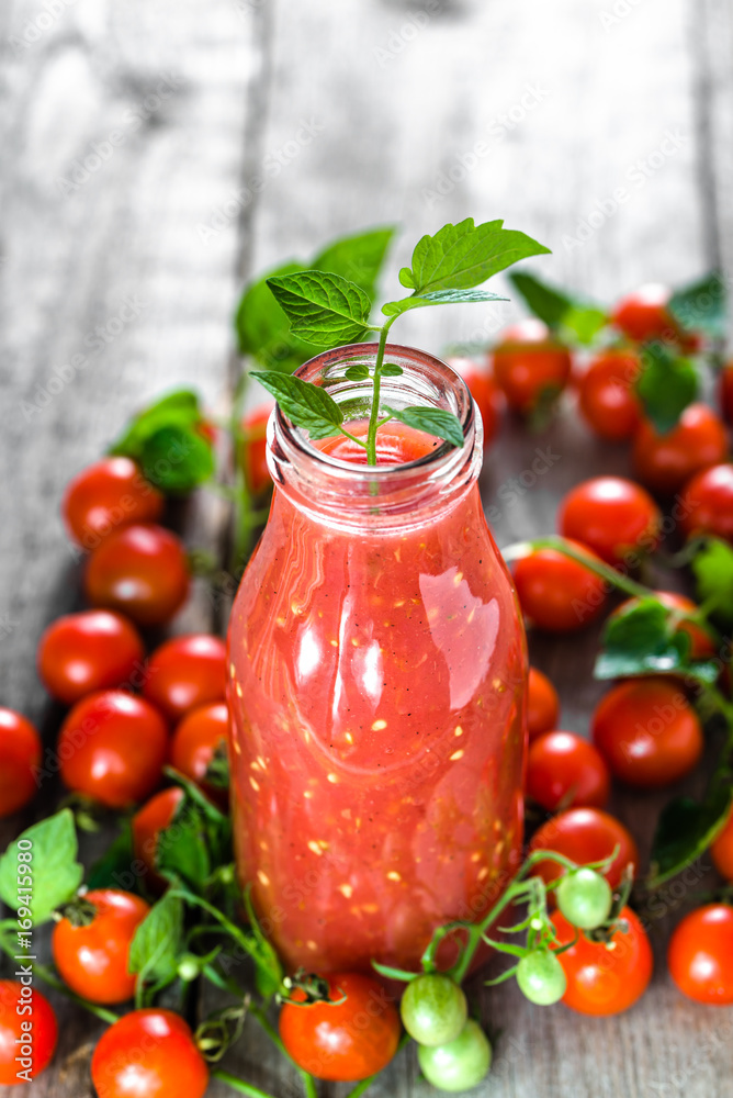 Bottle of tomato juice and fresh tomatoes, organic healthy food concept Bottle of tomato juice and fresh tomatoes, organic healthy food concept