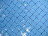 Iron mesh against the blue sky background