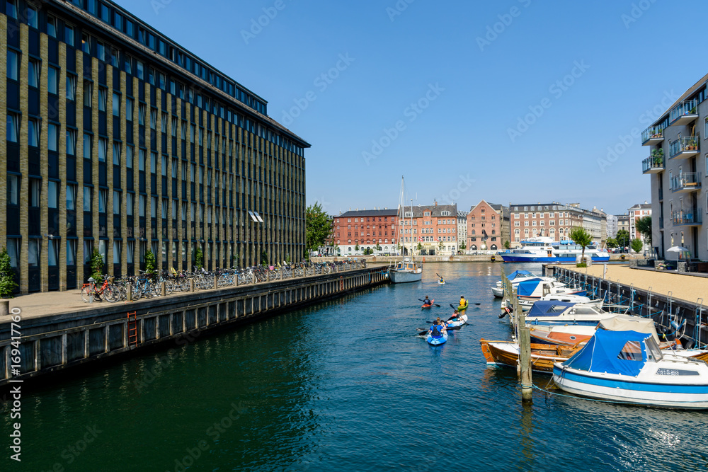  Children are kayaking in a water canal in Copenhagen, Denmark